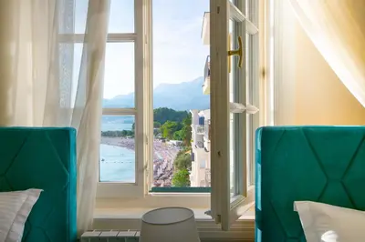 a room with a window with a view of the ocean at Luxury Apartments Montesan in Sveti Stefan