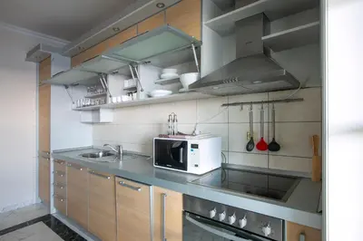 a kitchen with a sink and a microwave at Luxury Apartments Montesan in Sveti Stefan
