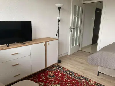 a living room with a flat screen tv on a dresser at City View Studio in Podgorica