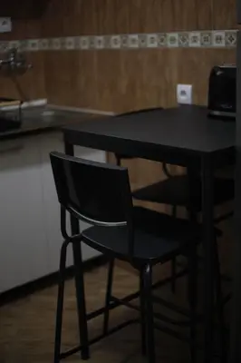 a black table and a black chair in a kitchen at City View Studio in Podgorica