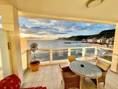 a balcony with a table and chairs and a view of the ocean at Apartments AriaSana-5m from the beach in Dobra Voda