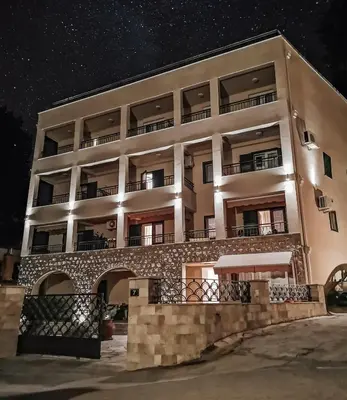 an apartment building at night with a starry sky at Guest House Medin in Petrovac na Moru