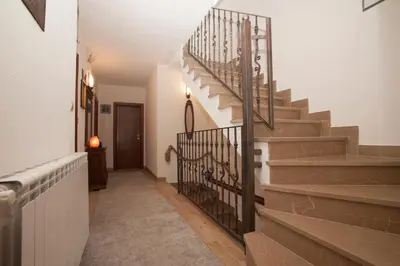 a hallway with stairs in a house at Guest House Medin in Petrovac na Moru