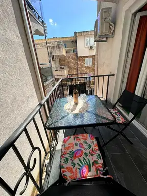 a balcony with a table and chairs on a balcony at D&D in Bar