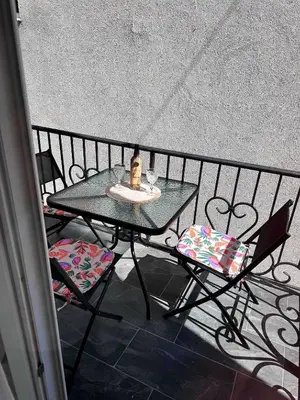 a table and two chairs on a balcony at D&D in Bar