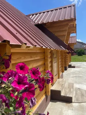 a building with red flowers on the side of it at Cozy bungallows in Podgorica
