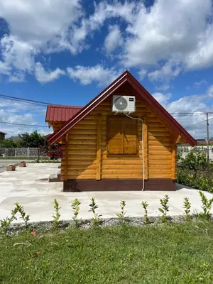 a log cabin with a air conditioner on the roof at Cozy bungallows in Podgorica