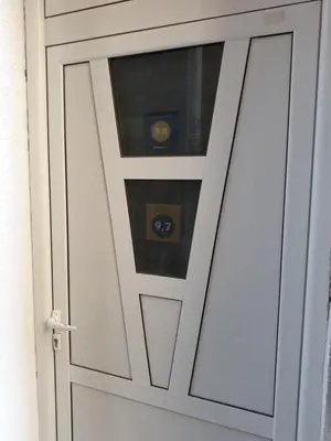 a white door with a window in it at Apartments Teodora Obala in Petrovac na Moru