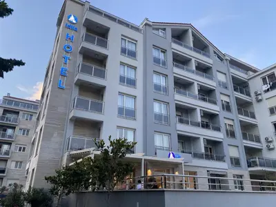 a large white building with a sign on it at Apartmani More in Budva