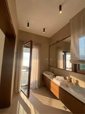a bathroom with a tub and a sink and a mirror at Belsize Villas in Budva