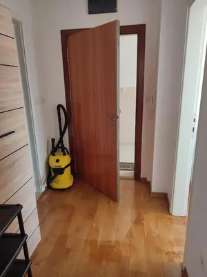 a room with a wooden door and a yellow object at Apartman Fontana in Budva