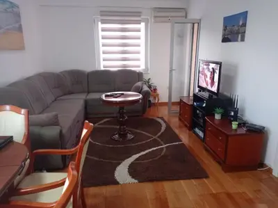 a living room with a couch and a table at Apartman Fontana in Budva