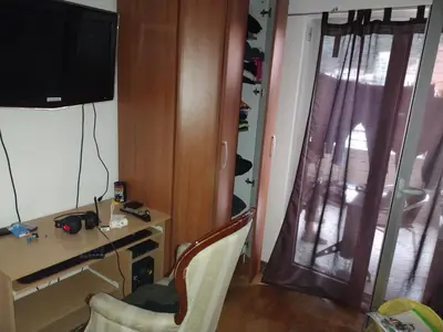 a room with a desk and a tv on a wall at Apartman Fontana in Budva