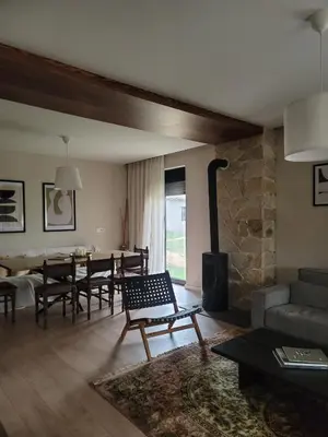 a living room with a fireplace and a dining room at Casa L in Ulcinj