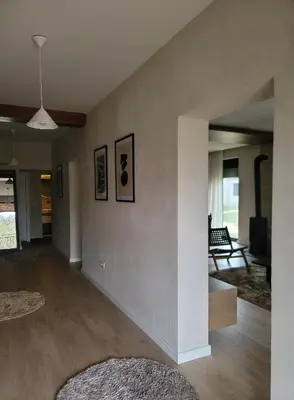 a living room with white walls and wooden floors at Casa L in Ulcinj