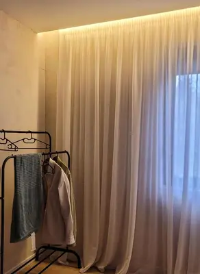 a curtain in a room with a window at Casa L in Ulcinj
