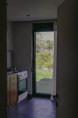 a kitchen with a door open to a yard at Casa L in Ulcinj