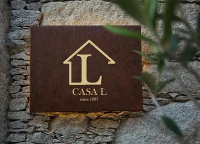 a plaque on a stone wall with a house on it at Casa L in Ulcinj