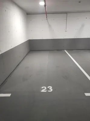 an empty parking garage with the number on the floor at D&M Studio Apartments in Bar