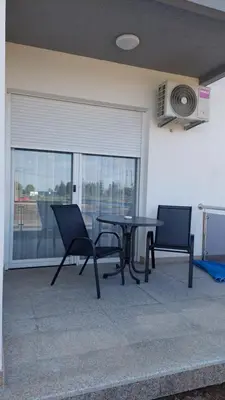 a table and chairs in a room with a window at D&M Studio Apartments in Bar