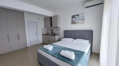 a bedroom with a bed with two towels on it at D&M Studio Apartments in Bar