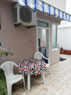 a table and chairs on the patio of a house at Apartments Familia in Budva