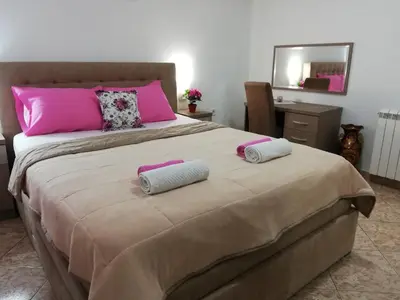 a large bed with two towels on top of it at Apartments Familia in Budva