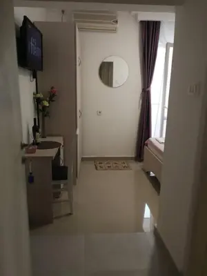 a room with a hallway with a mirror and a window at Apartments Familia in Budva