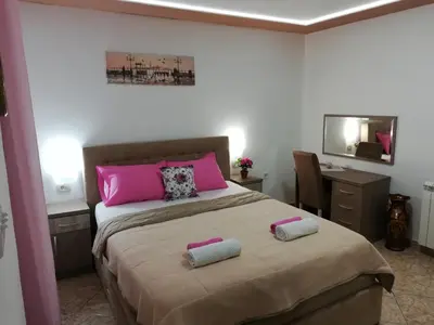 a bedroom with a bed with two pillows on it at Apartments Familia in Budva