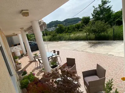 a patio with a table and chairs on a house at Starlight Apartments in Ulcinj