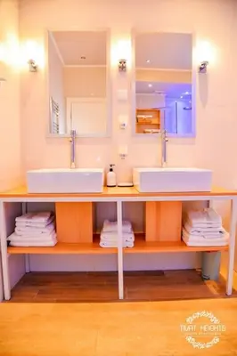 a bathroom with two sinks and a mirror at A1 2 beds 2 baths Lux Condo Pool Sea Views in Tivat