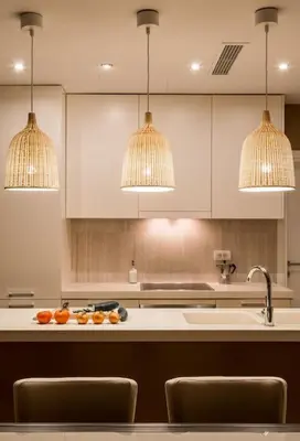 a kitchen with a counter with a sink and three lights at A1 2 beds 2 baths Lux Condo Pool Sea Views in Tivat