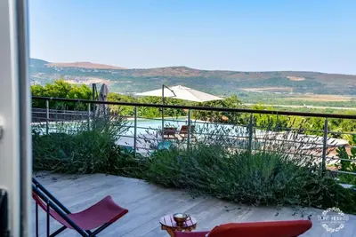 a balcony with chairs and a view of a pool at A1 2 beds 2 baths Lux Condo Pool Sea Views in Tivat