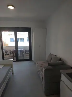 a living room with a couch and a table at Top Apartments in Dobra Voda