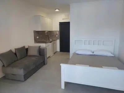 a living room with a couch and a table at Top Apartments in Dobra Voda