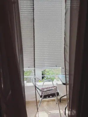 a chair sitting in a room with a window at Apartments Sara 2 in Ulcinj