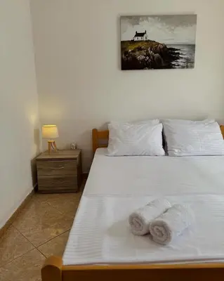 a bedroom with a bed with towels on it at Apartments Sara 2 in Ulcinj
