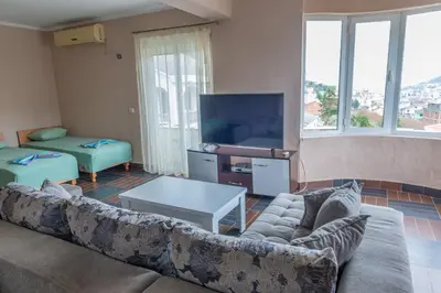 a living room with a couch and a flat screen tv at Nomad apartments in Ulcinj