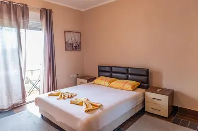a bedroom with a bed and a large window at Nomad apartments in Ulcinj