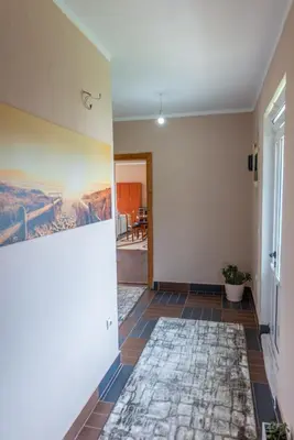 a hallway with a tile floor and a painting on the wall at Nomad apartments in Ulcinj