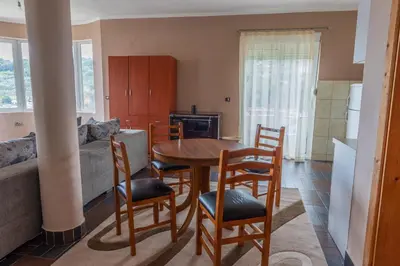 a kitchen with a table and chairs in a room at Nomad apartments in Ulcinj