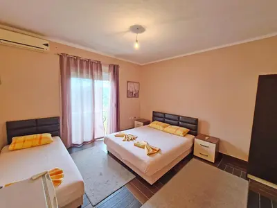 a hotel room with two beds and a window at Nomad apartments in Ulcinj