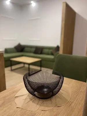 a black bowl sitting on top of a wooden table at Apartments KinGs in Petrovac na Moru