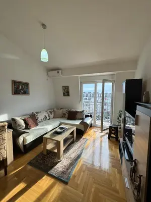 a living room with a couch and a table at Apartment 50 in Podgorica