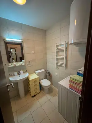 a bathroom with a toilet and a sink at Apartment 50 in Podgorica