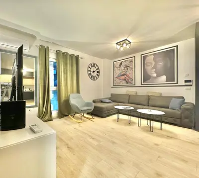 a living room with a couch and two tables at Modern One bedroom Apartment Budva in Budva
