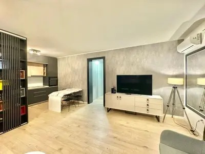 a living room with a flat screen tv on a wall at Modern One bedroom Apartment Budva in Budva