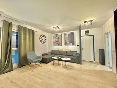 a living room with a couch and a table at Modern One bedroom Apartment Budva in Budva
