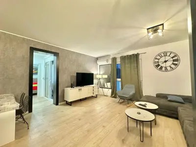 a living room with a couch and a tv at Modern One bedroom Apartment Budva in Budva