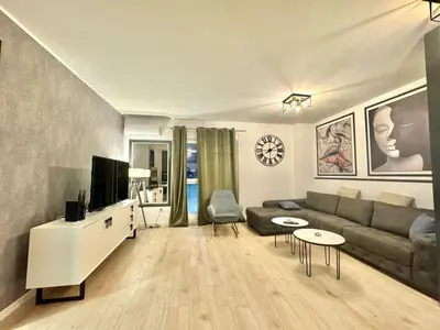 a living room with a couch and a tv at Modern One bedroom Apartment Budva in Budva
